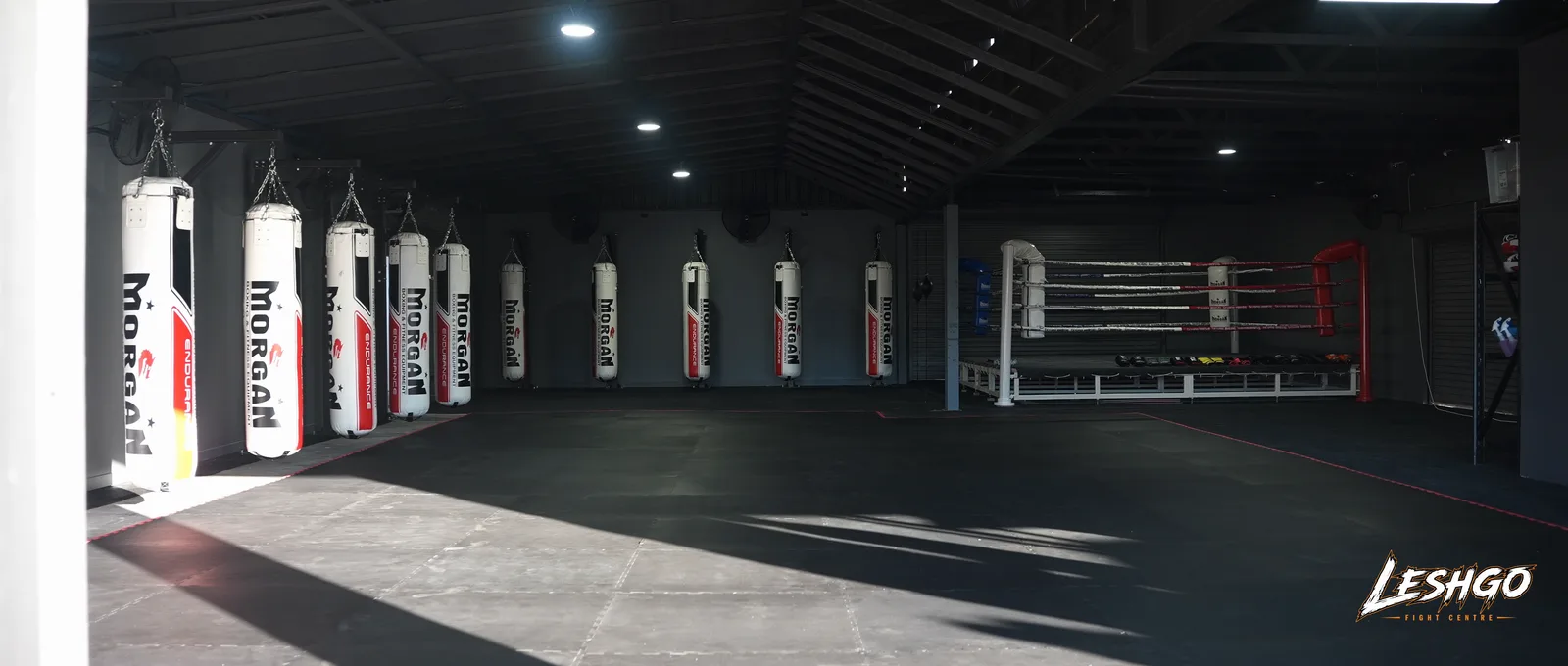 Training floor with heavy bags and boxing ring at LeshGo Fight Centre in Bulimba